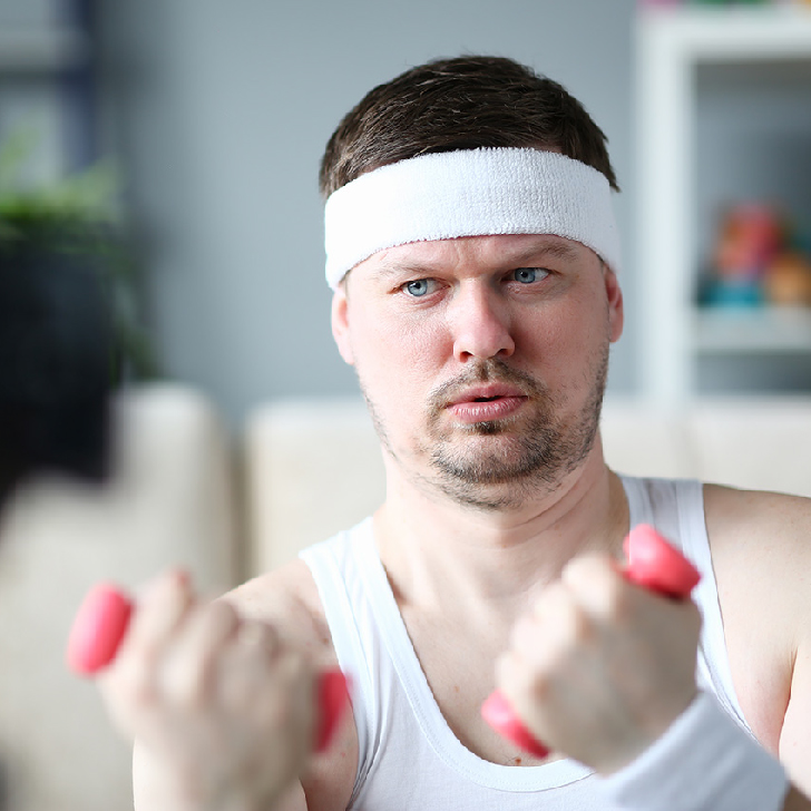Harry Smith wearing a headband and holding weights